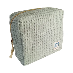 MUSTELA Neceser beige de algodón natural con productos para el cuidado y la higiene del bebe.