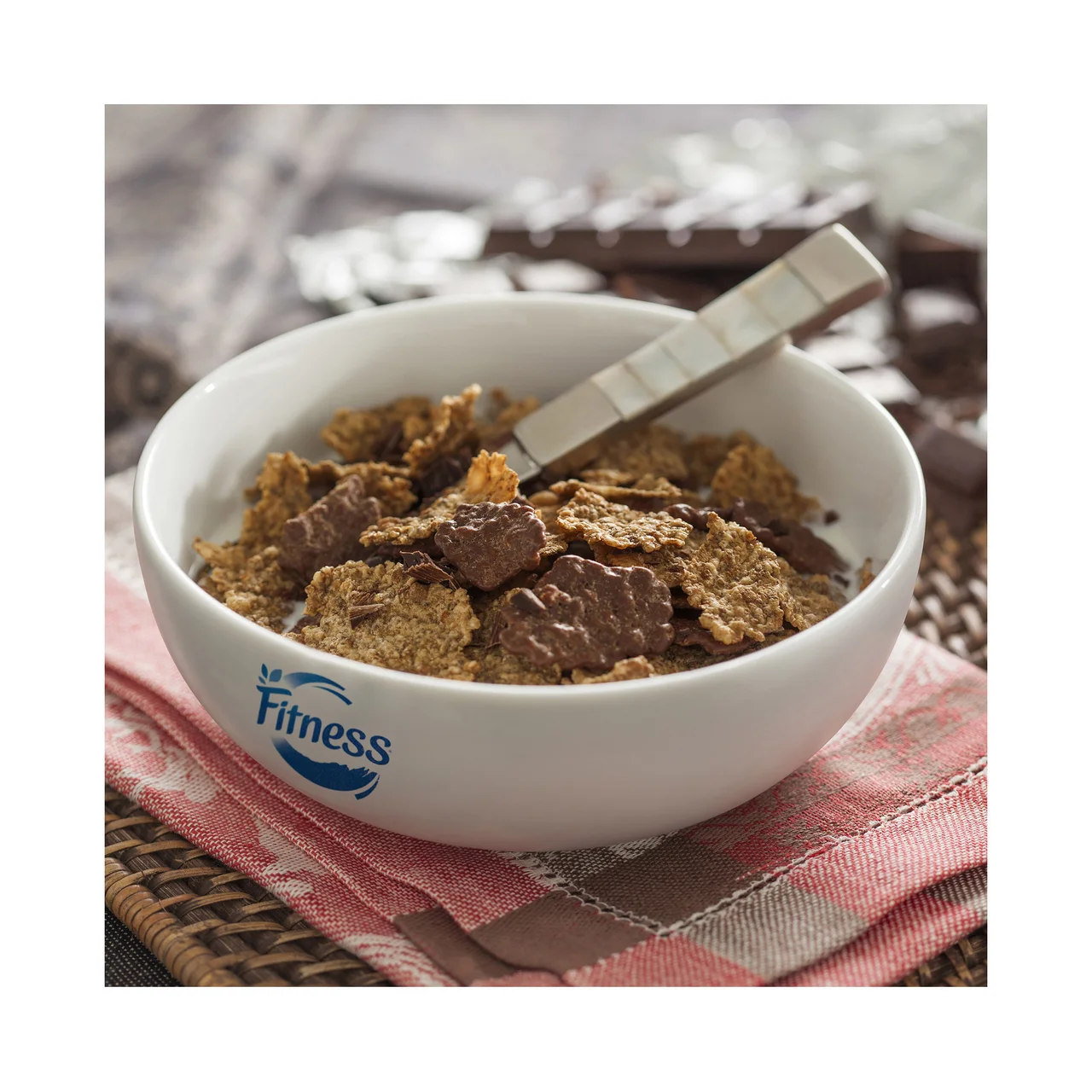 Fitness Copos de trigo integral, arroz y avena integral tostados, recubierto de chocolate con leche 375 g.